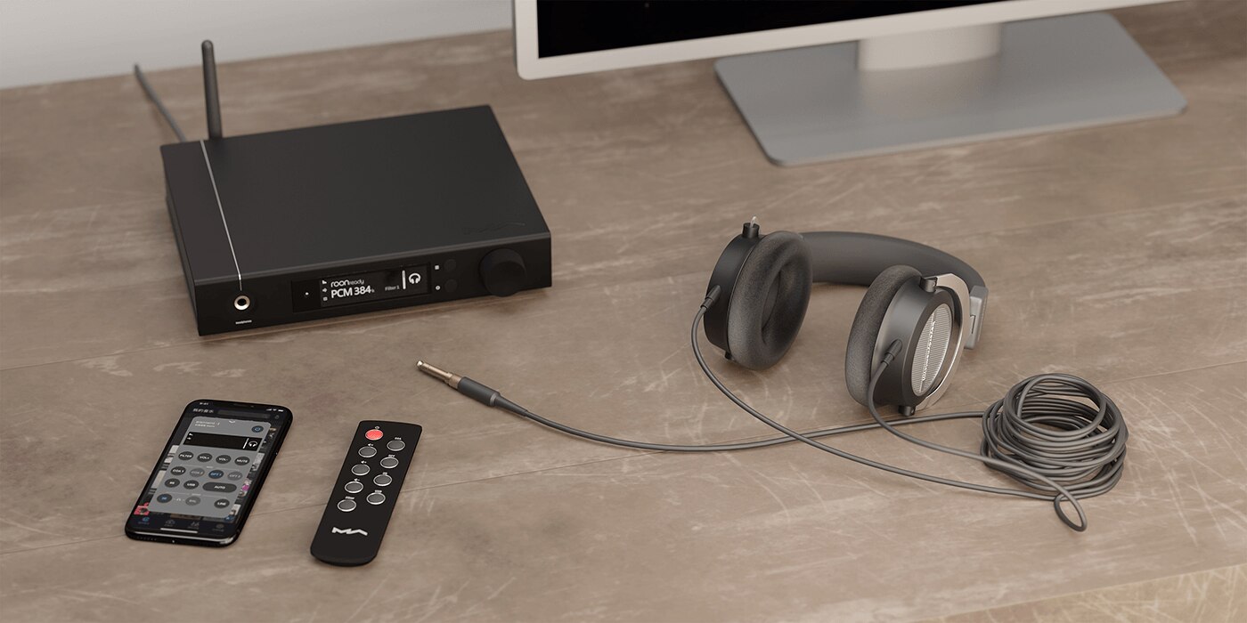 element i on desktop with remote control, smartphone, and headphones