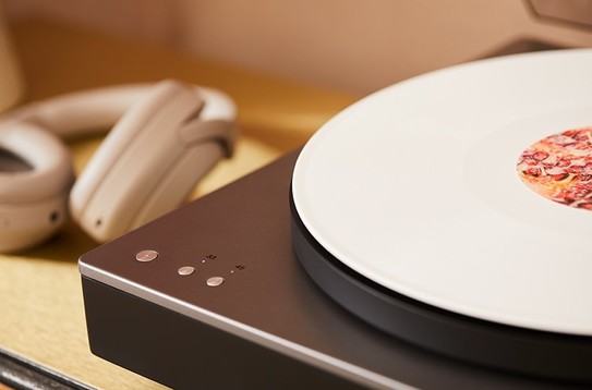 close-up of alva st turntable corner with white record and headphones